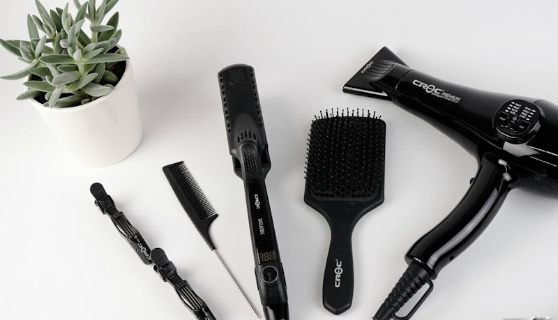 Hair styling tools and plants on a salon counter